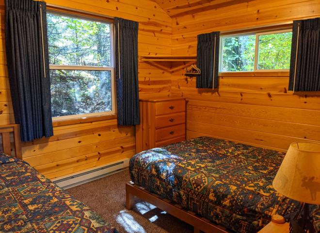 Bedroom with a full size bed, twin bed, lofted twin bed, and a ensuite bathroom.