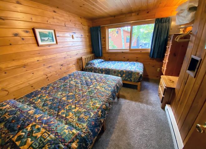 Bedroom with a full size bed and twin.