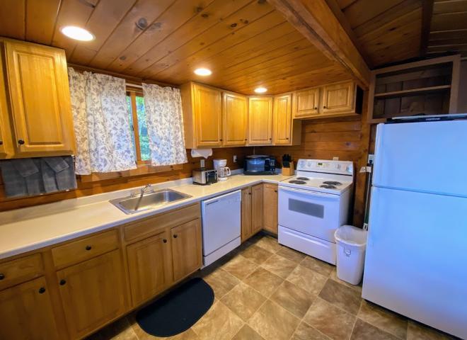 Kitchen with a refrigerator, stove, and dishwasher.