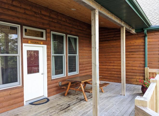 Deck entrance with picnic table.