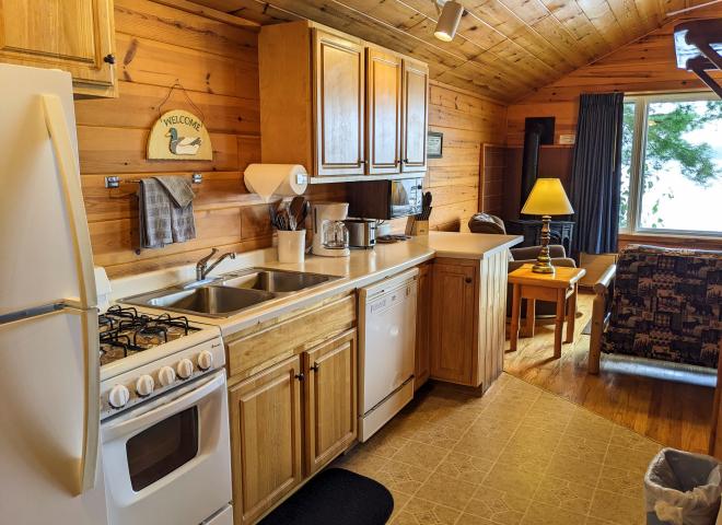 Kitchen with a refrigerator, stove, and dishwasher.