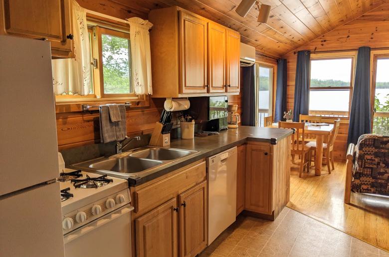 Kitchen area with a refrigerator, gas stove, and dishwasher.