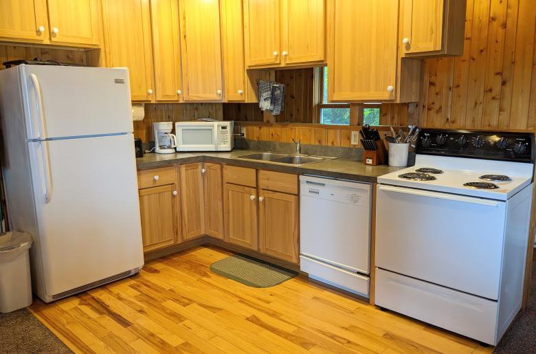Kitchen with a refrigerator, stove, and dishwasher.