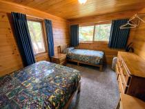 Bedroom with a full size bed and twin.