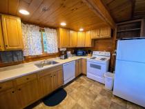 Kitchen with a refrigerator, stove, and dishwasher.