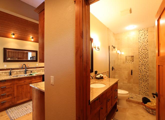 Main floor bathroom with a shower and granite.