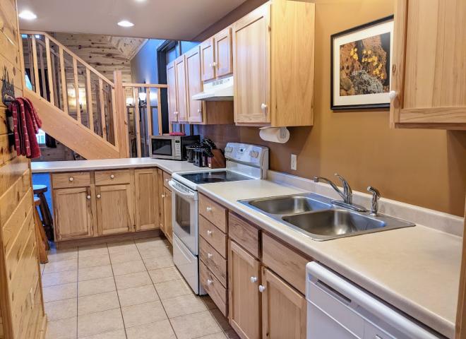 Kitchen with refrigerator, stove, and dishwasher.