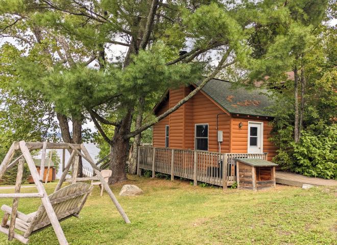 Exterior of Minnesota with firepit and swinging bench.