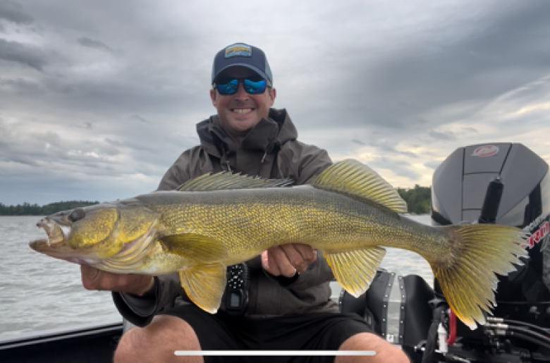 Jason Freed holding a large Walleye